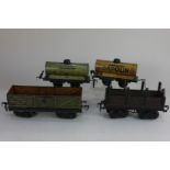 A collection of four Fandor O gauge model railway wagons, comprising two tank wagons and two open