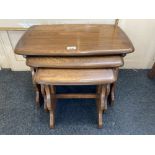 An Ercol nest of three occasional tables, with pierced side supports, 57cm