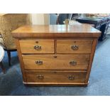 A Victorian walnut chest of two short over two long drawers with brass drop handles and scroll