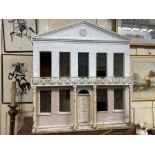 A Regency style white painted wooden dolls house, the hinged facade with pointed pediment, nine