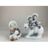 Two Lladro porcelain figures, Eskimo Riders and Eskimo playing with polar bear cub, both in original