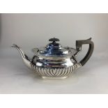 An Edward VII silver teapot, maker Hammond, Creake & Co, Sheffield 1904, of half reeded form 21.