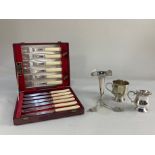 A cased set of six pairs of silver plated fish knives and forks, two small mugs, and an epergne with