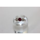A ruby and diamond three stone ring in 18ct white gold