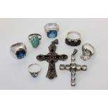 Six various gem set silver rings, a silver and garnet cross and a moonstone cross
