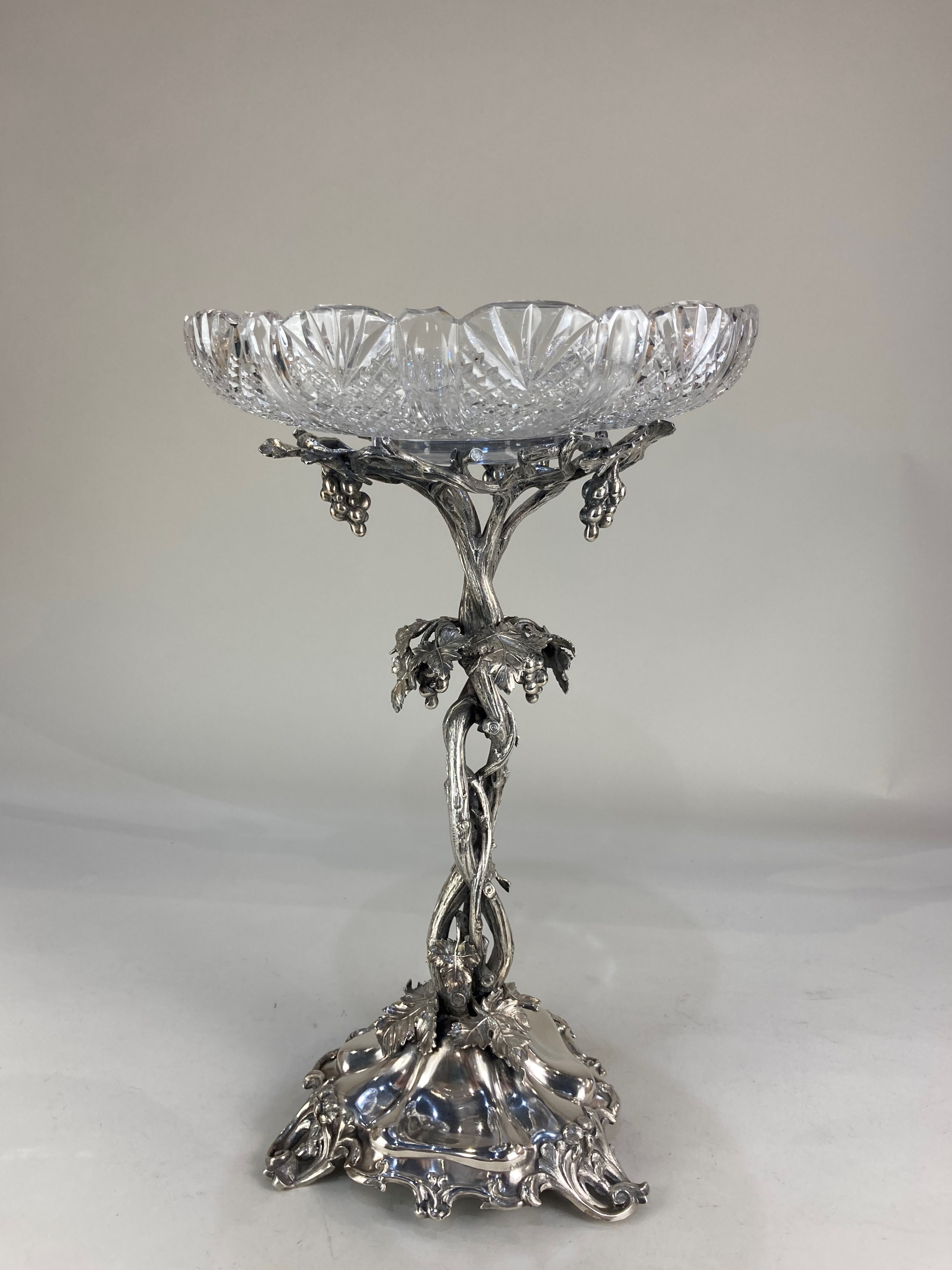 An Elkington & Co style silver plated table centrepiece, the entwined grapevine design supporting