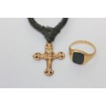 A bloodstone signet ring in yellow gold, and a gold crucifix on black cord (both unmarked)
