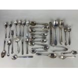 A collection of George III and later silver spoons, forks, a butter knife and sugar tongs, including