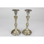 A pair of Portuguese silver table candlesticks, round bases on six bracket feet with baluster