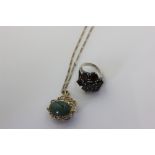 A hardstone pendant set with two cabochon in a gold swivel mount on chain, and a garnet cluster