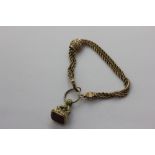 A Victorian gold bracelet the three row rope link band with slides and a cornelian fob seal 15g