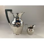 A Victorian silver hot water jug, marks worn, London 1899, of half reeded form with later