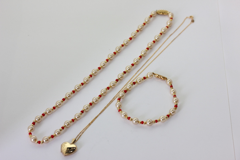 A 9ct gold heart locket on a curb link neckchain 3.1g, an imitation pearl and coral necklace and