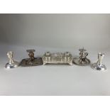 A silver plated desk stand, with two cut glass inkwells, two silver plated chamber sticks, and a