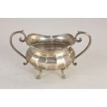 A George V silver two handle sugar bowl, oval shape with scroll handles on hoofed feet, Birmingham