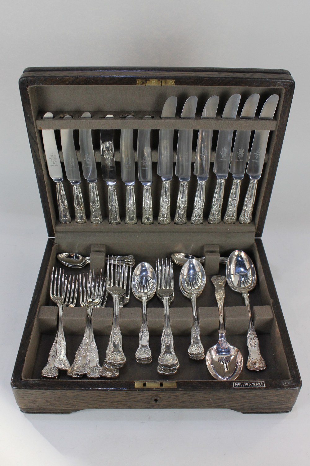 A Mappin & Webb oak canteen case, containing a Mappin & Webb silver plated kings pattern cutlery