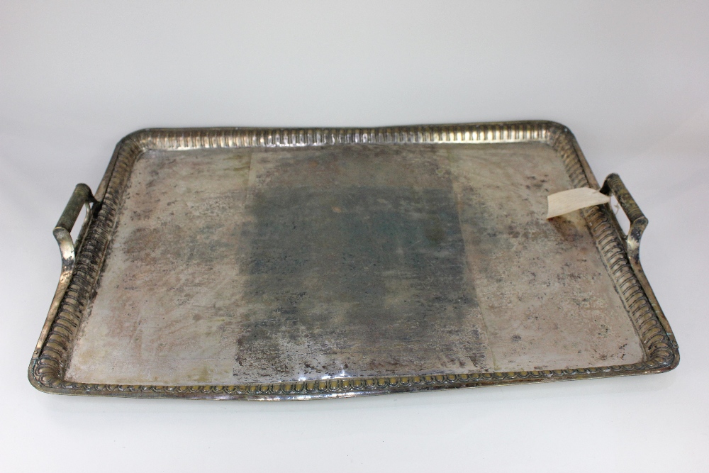 A large silver plated rectangular tray with bale handles and fluted bouge, 72cm by 53cm