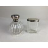 A George V silver mounted cut glass scent bottle, marks worn, Birmingham 1912, and a silver lidded