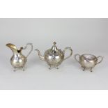A Portuguese silver teapot with matching sugar basin and cover and milk jug, with bellied bodies