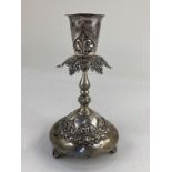 A Portuguese silver candlestick, hallmarked Lisbon, with embossed scrolling design and gilt