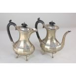 A George V silver coffee pot and matching water jug, faceted baluster shape on hoof feet, maker