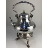 An Elkington & Co silver plated large teapot on stand, with engraved scrolling floral design, the