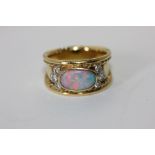 An opal and diamond ring set with an oval cabochon doublet and two trefoils of diamonds 8.4g gross
