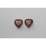 A pair of ruby and diamond ear clips heart shaped with a pave set central cluster