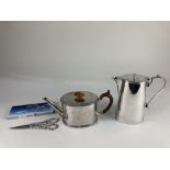An Elkington & Co silver plated oval teapot, a silver plated hot water jug, and a pair of Godinger