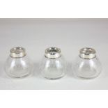 A set of three George V silver mounted controlled bubble clear glass pots, maker Levi & Salaman,