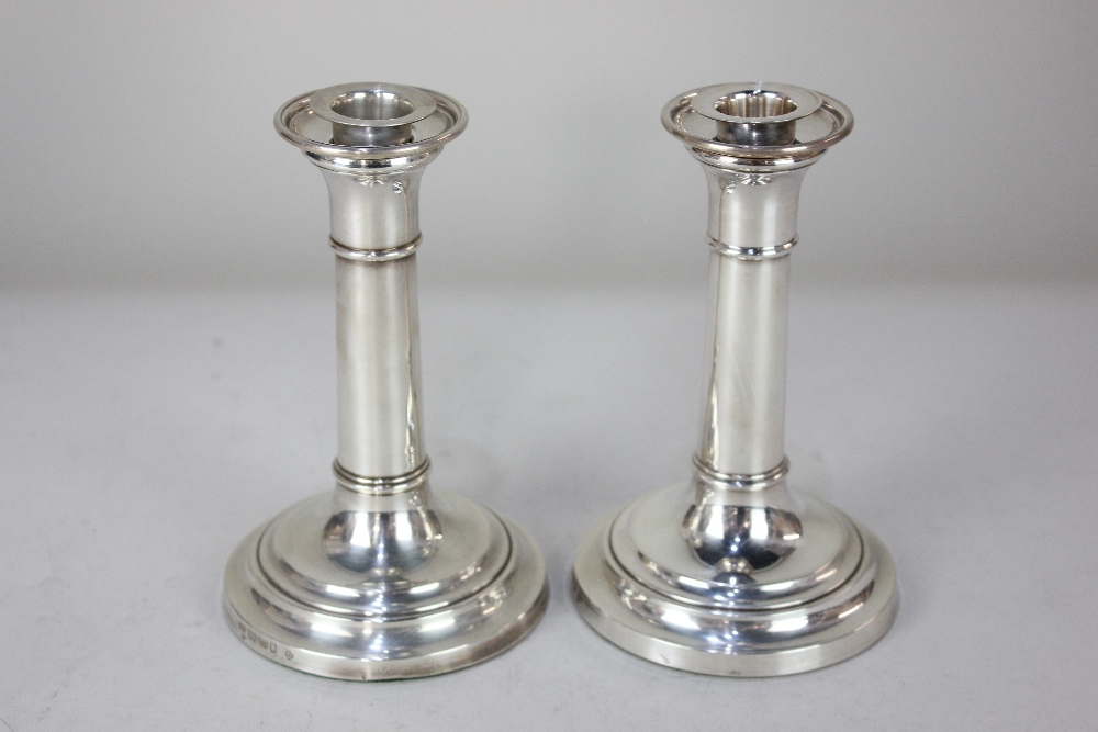 A pair of Elizabeth II silver dwarf candlesticks, maker John Bull Ltd, Birmingham 2000, of plain