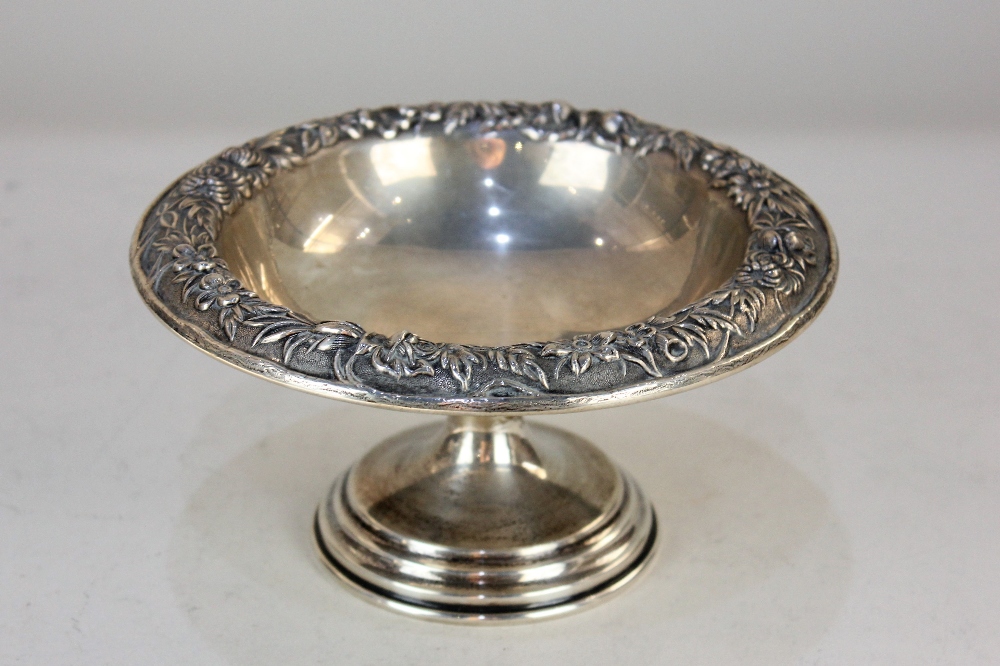 An American sterling silver pedestal bowl, with floral embossed border, stamped S Kirk & Son,