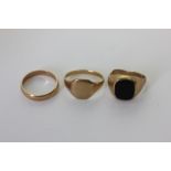 A 9ct gold and black onyx signet ring; a 9ct gold signet ring; and a 9ct gold wedding ring 9.7g