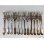 A set of twelve Victorian silver fiddle pattern table forks, maker George William Adams, London