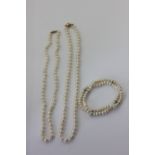 A cultured pearl necklace on 9ct gold ball clasp; a pearl necklace on an 18ct gold torpedo clasp;