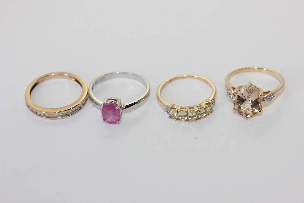 A pink sapphire ring, a diamond half hoop ring and two other gem set rings