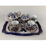 A Sandland Imari pattern porcelain cabaret tea set, comprising teapot, sugar bowl and cover, milk