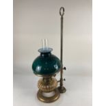 An adjustable brass oil table lamp circular stand and square brass rod with fluted glass oil well