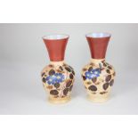 A pair of Victorian milk glass vases, of baluster form, decorated with blue flowers, on brown