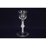 An 18th century wine glass, flared ogee bowl, on double series opaque white twist stem with centre