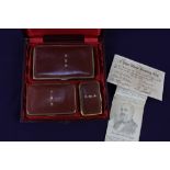 A Victorian presentation box of a three piece red leather mounted brass cigar, cigarette and vesta