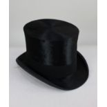 A Henry Heath Ltd black silk top hat, inner measurements 20cm by 16cm, in original carry case