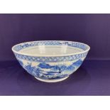 A large Chinese porcelain blue and white bowl, depicting dwellings in a landscape (a/f) 29.5cm