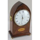 A Comitti of London mahogany lancet shaped mantle clock, the circular dial with Roman numerals,