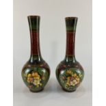 A pair of Victorian Doulton Lambeth pottery bottle vases by Mary Mitchell, with floral spray