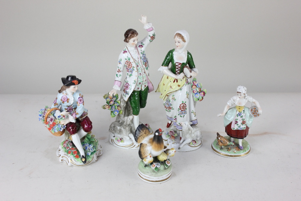 A Sitzendorf porcelain pair of figures, a lady holding a tambourine, 20cm, a gentleman with arm