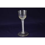 An 18th century wine glass, bucket type bowl with moulded flutes, on a double series twist stem,