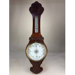 A carved mahogany banjo aneroid barometer, 83cm