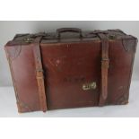 A large brown leather suitcase, with straps and initials, 68cm