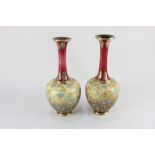 A pair of Doulton Lambeth 'Slaters patent' stoneware bottle vases, each decorated with blue and
